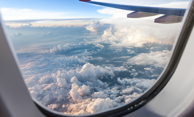 tips for a better flight post. picture is of looking out airplane window into clouds below